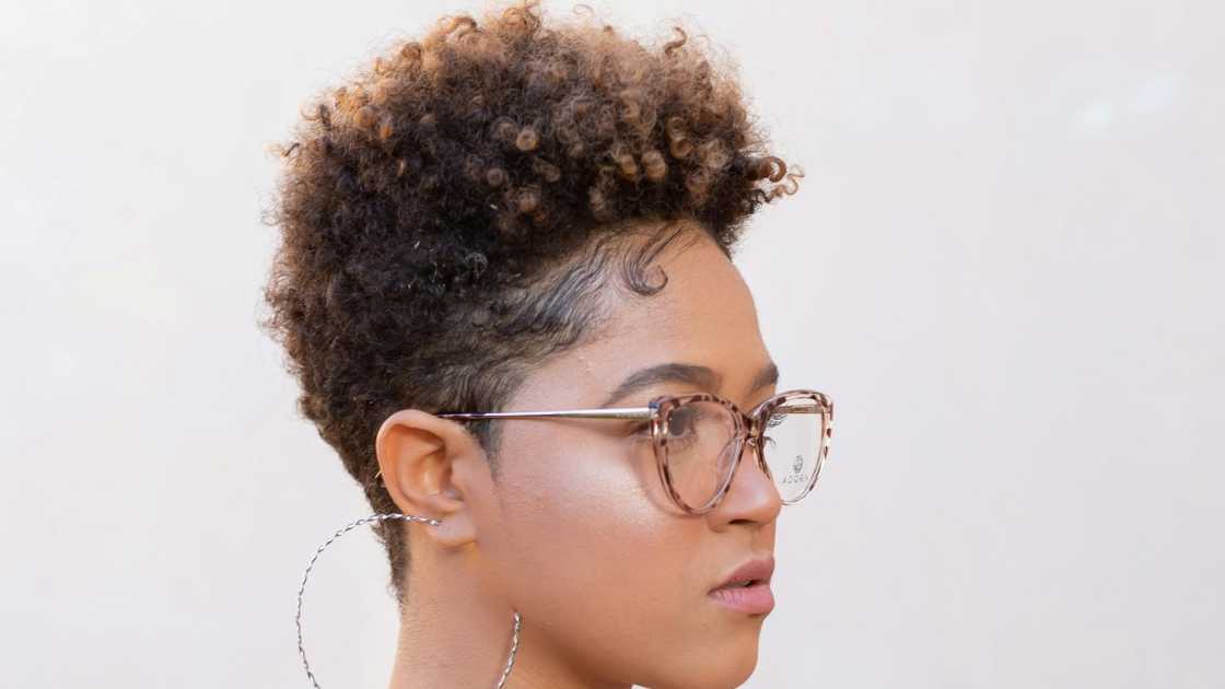 The side view of a woman with a pixie haircut