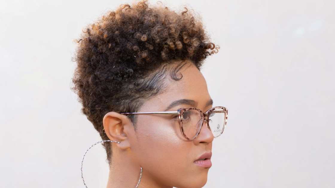 The side view of a woman with a pixie haircut The side view of a woman with a pixie haircut