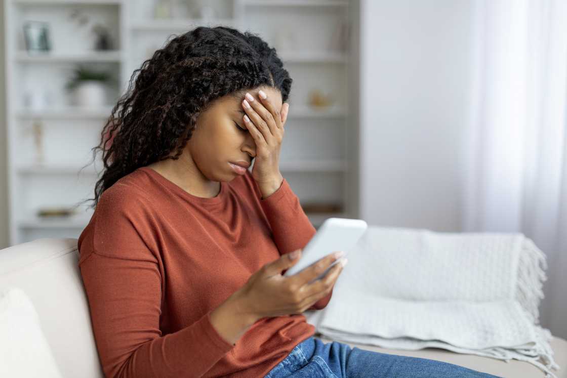 A disappointed woman hodling a phone