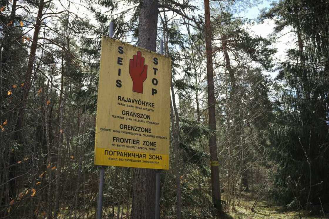 A sign reads 'Stop, border area' in a forest in southeastern Finland A sign reads 'Stop, border area' in a forest in southeastern Finland