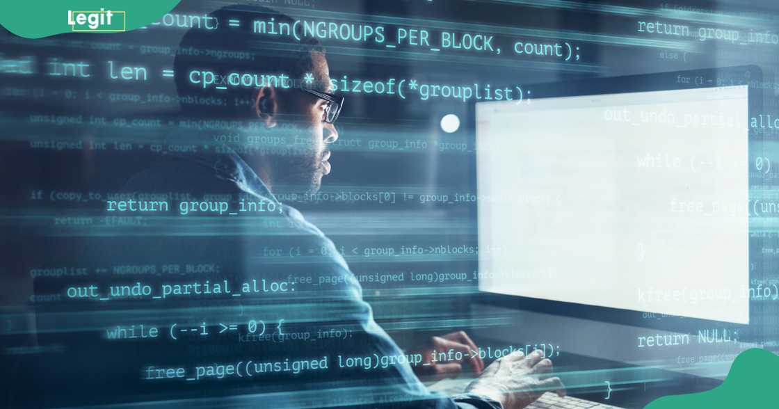 A male software engineer works in the office with superimposed lines of computer code showing what he is working on. A male software engineer works in the office with superimposed lines of computer code showing what he is working on.