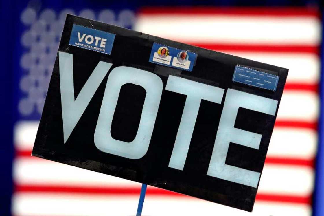 An attendee holds up a sign at an election rally in Las Vegas, Nevada, on November 1, 2022