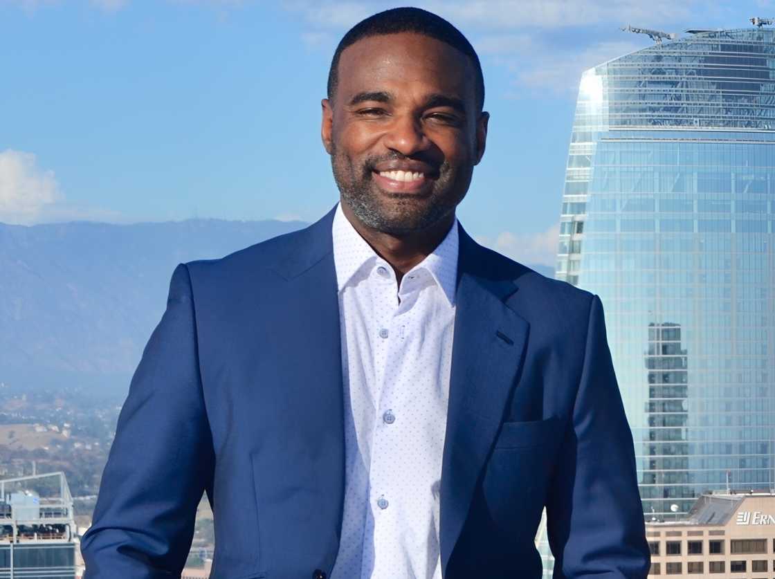 Rashaun Williams poses against the backdrop of the city's skyline.