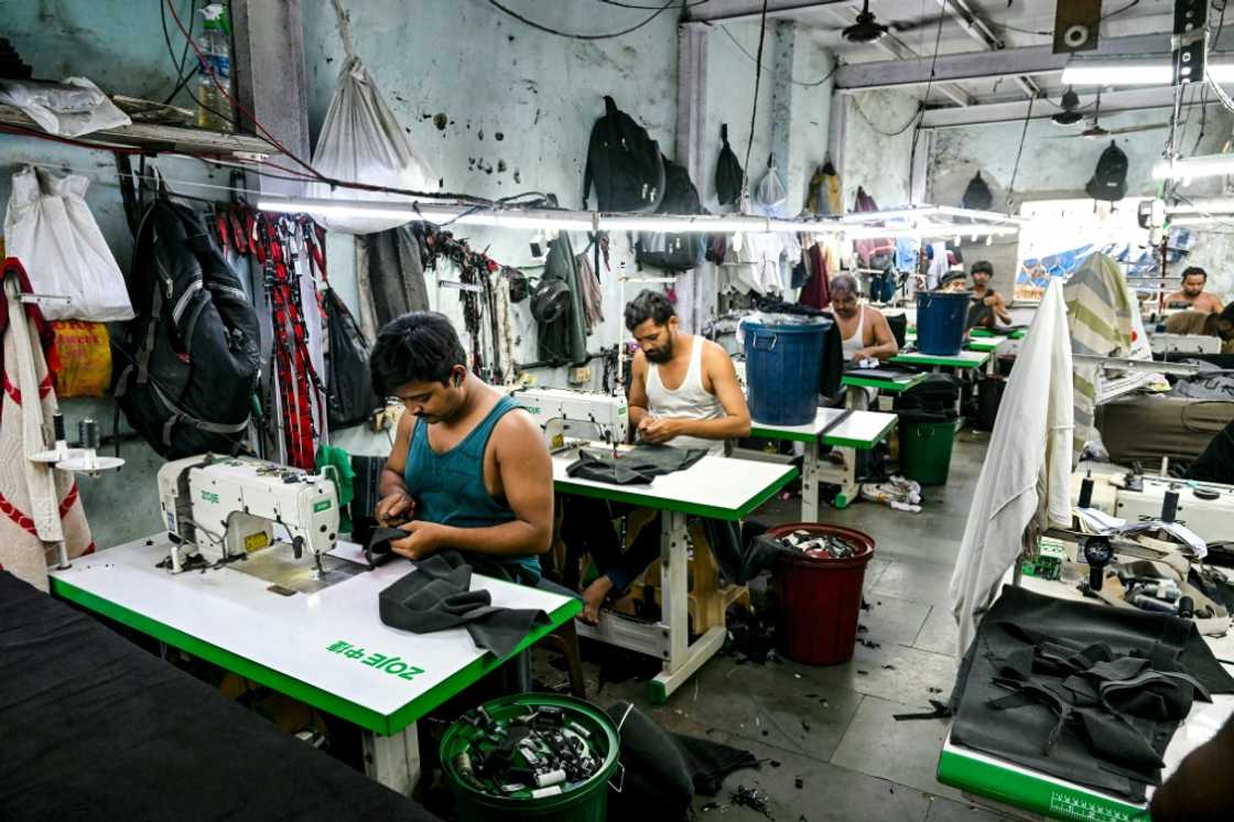 Homes, workshops and small factories adjoin each other, crammed between two railway lines and a rubbish-choked river Homes, workshops and small factories adjoin each other, crammed between two railway lines and a rubbish-choked river