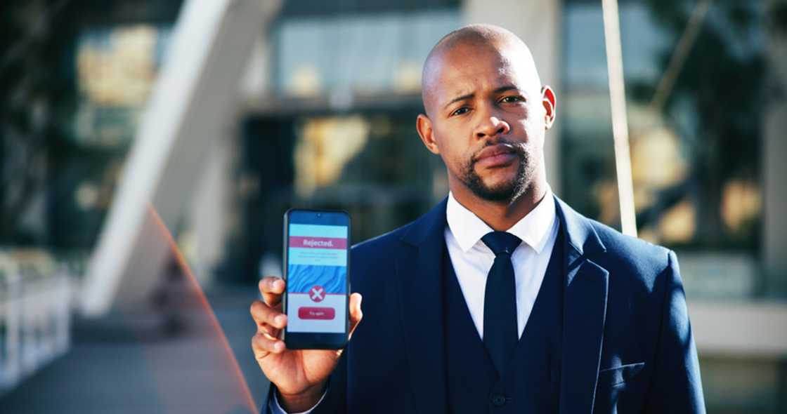 Outside a courthouse, a phone displays news of denied bail.