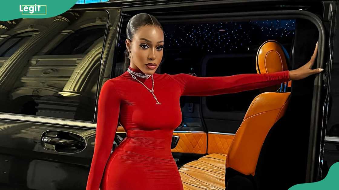 Uche Montana in a red dress.