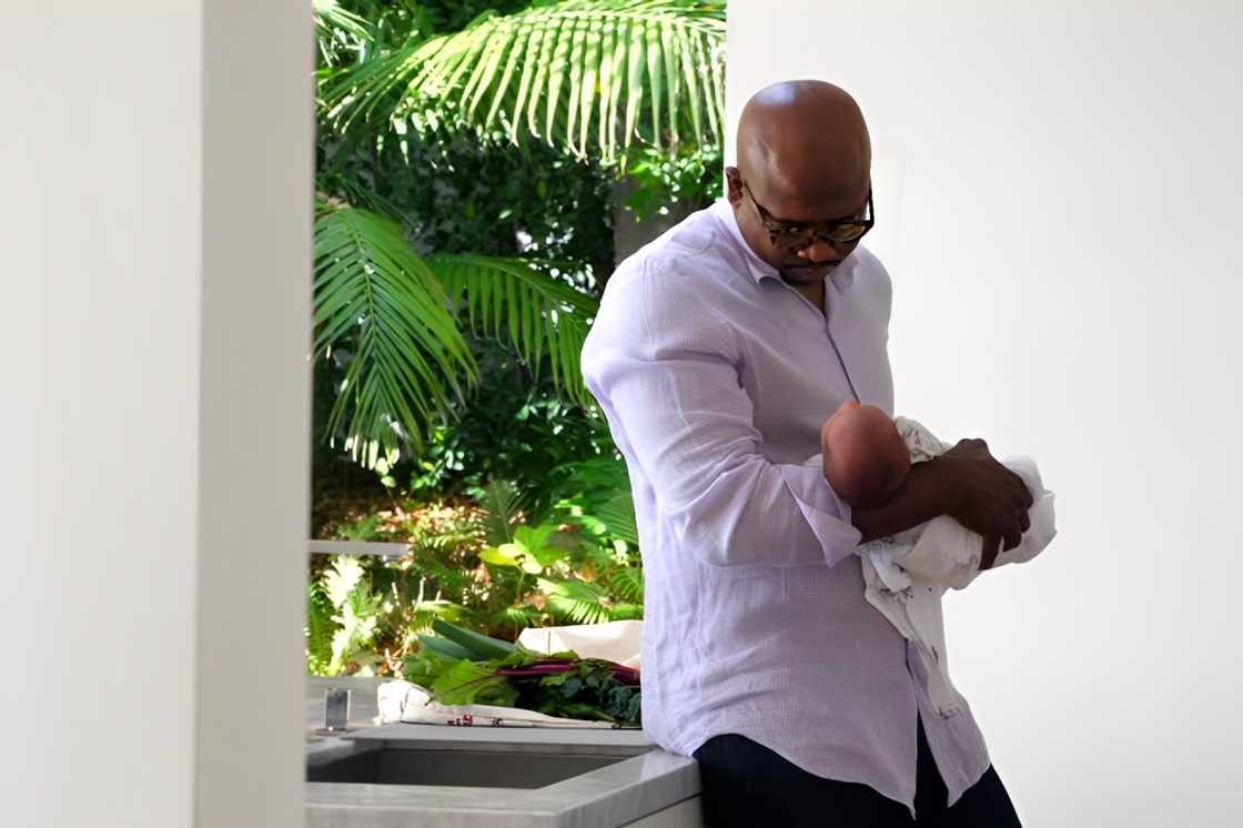 Father holding newborn son Father holding newborn son