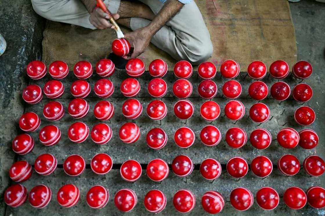 In this photograph taken on September 14, 2023, a worker polishes cricket balls at a workshop in Meerut in India's northern state of Uttar Pradesh In this photograph taken on September 14, 2023, a worker polishes cricket balls at a workshop in Meerut in India's northern state of Uttar Pradesh