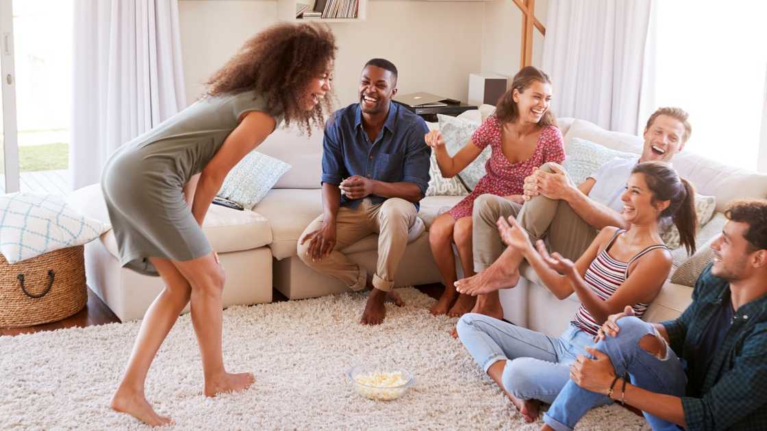 A group of individuals play party games together.