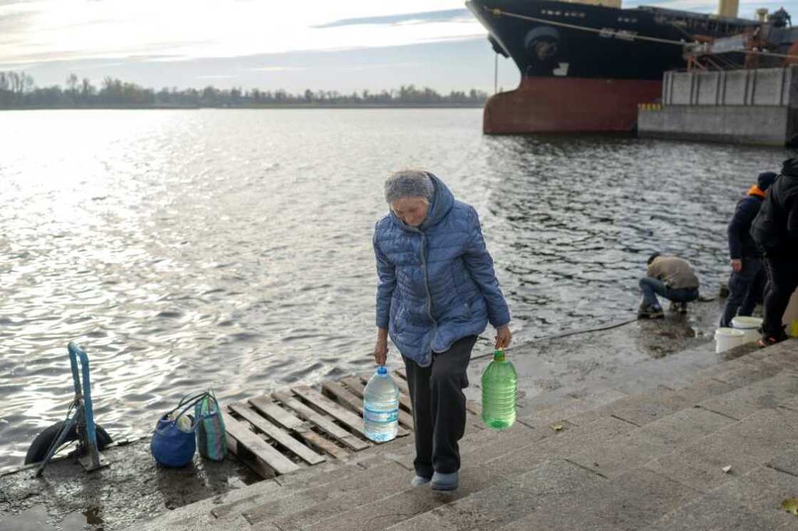 Local people are collecting water from the Dnipro river in Kherson,
now a natural dividing line between Ukraine's forces and Russians on the opposing bank