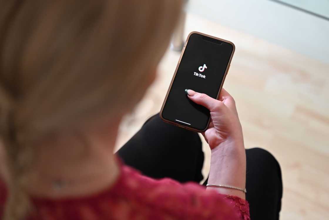 A lady accessing TikTok on a smartphone A lady accessing TikTok on a smartphone