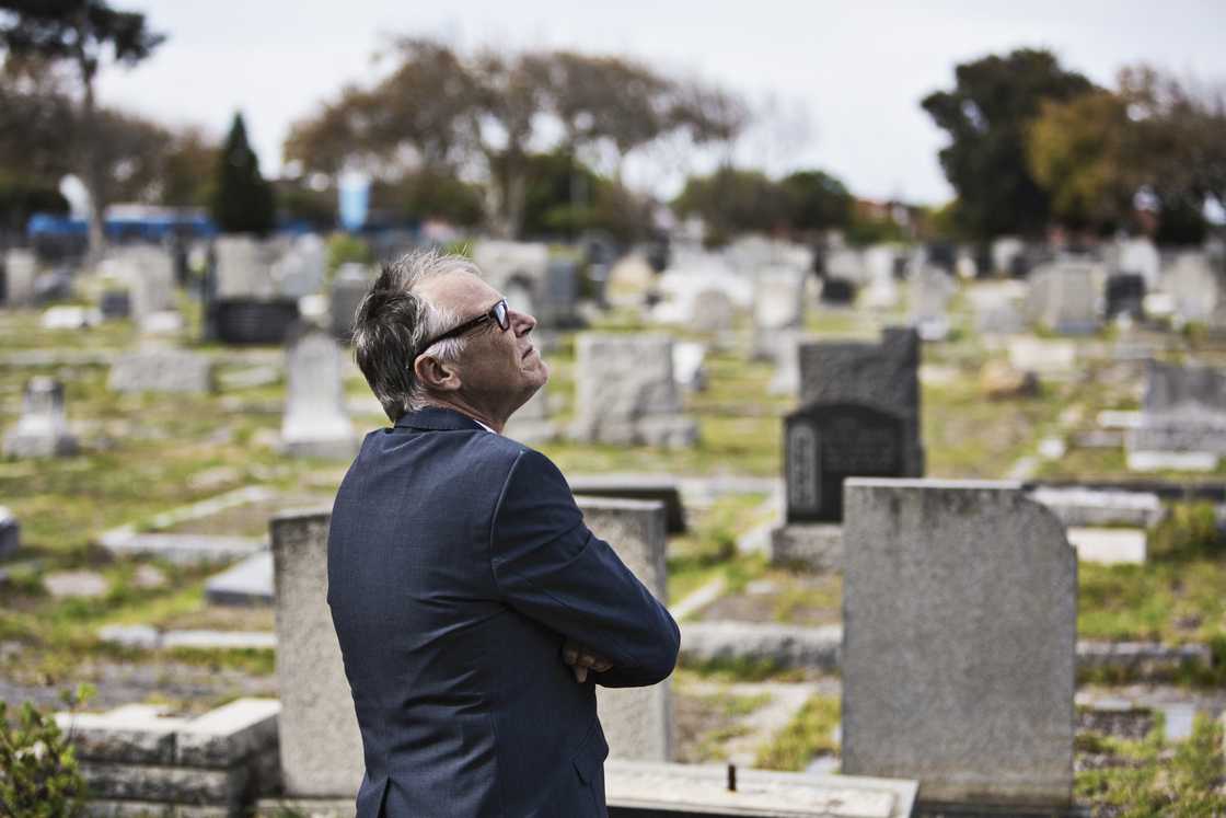 A man standing at a cemetery A man standing at a cemetery