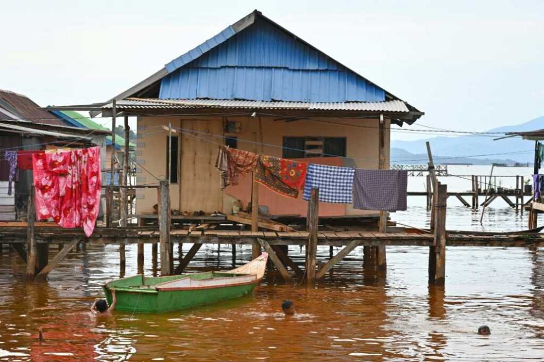 Children swim in polluted seawater in Pomalaa