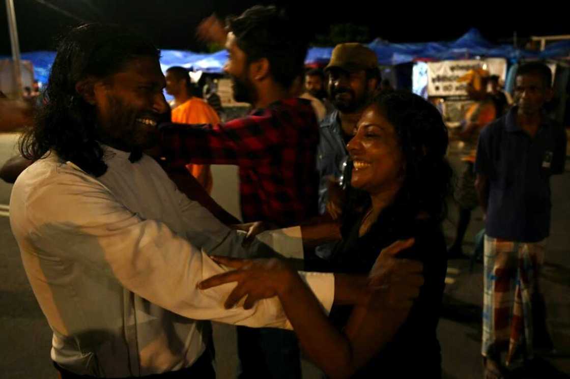 A stone's throw from what had days earlier been the office of President Gotabaya Rajapaksa, Sri Lankans smile wearily at their compatriots as they dance, hand out sweets, embrace each other or wave the national flag A stone's throw from what had days earlier been the office of President Gotabaya Rajapaksa, Sri Lankans smile wearily at their compatriots as they dance, hand out sweets, embrace each other or wave the national flag