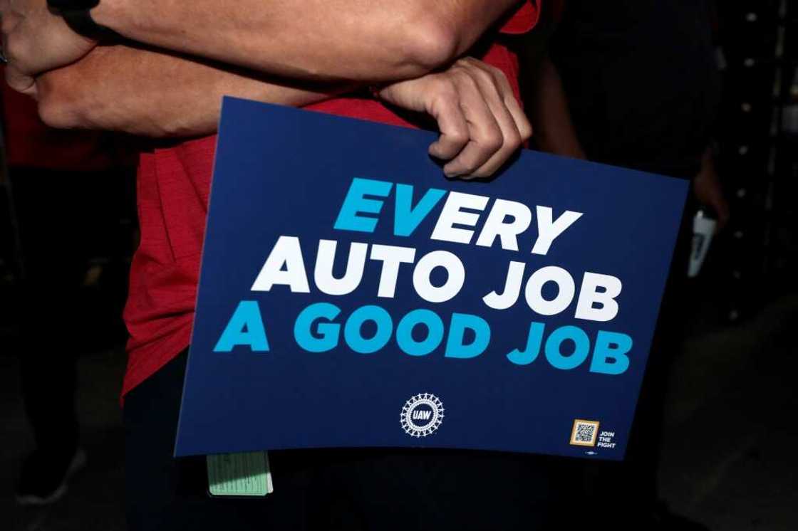 United Auto Workers members hold signs outside the Stellantis auto plant in Sterling Heights, Michigan, on July 12, 2023 United Auto Workers members hold signs outside the Stellantis auto plant in Sterling Heights, Michigan, on July 12, 2023