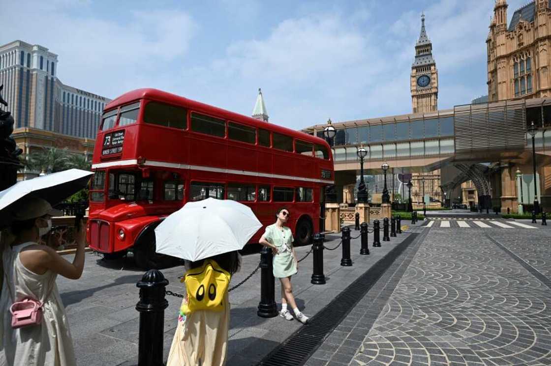 Chinese tourists take photos outside Macau’s Londoner Casino on Chinese tourists take photos outside Macau’s Londoner Casino on