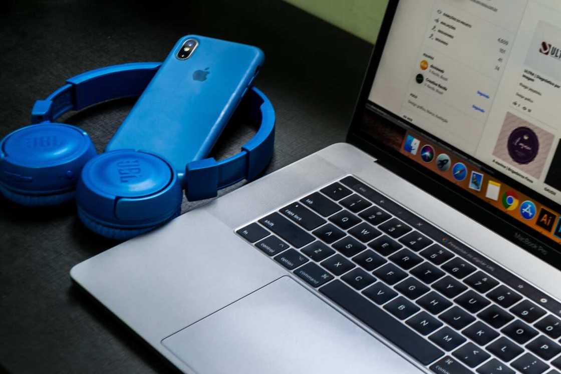 A blue iPhone next to a computer