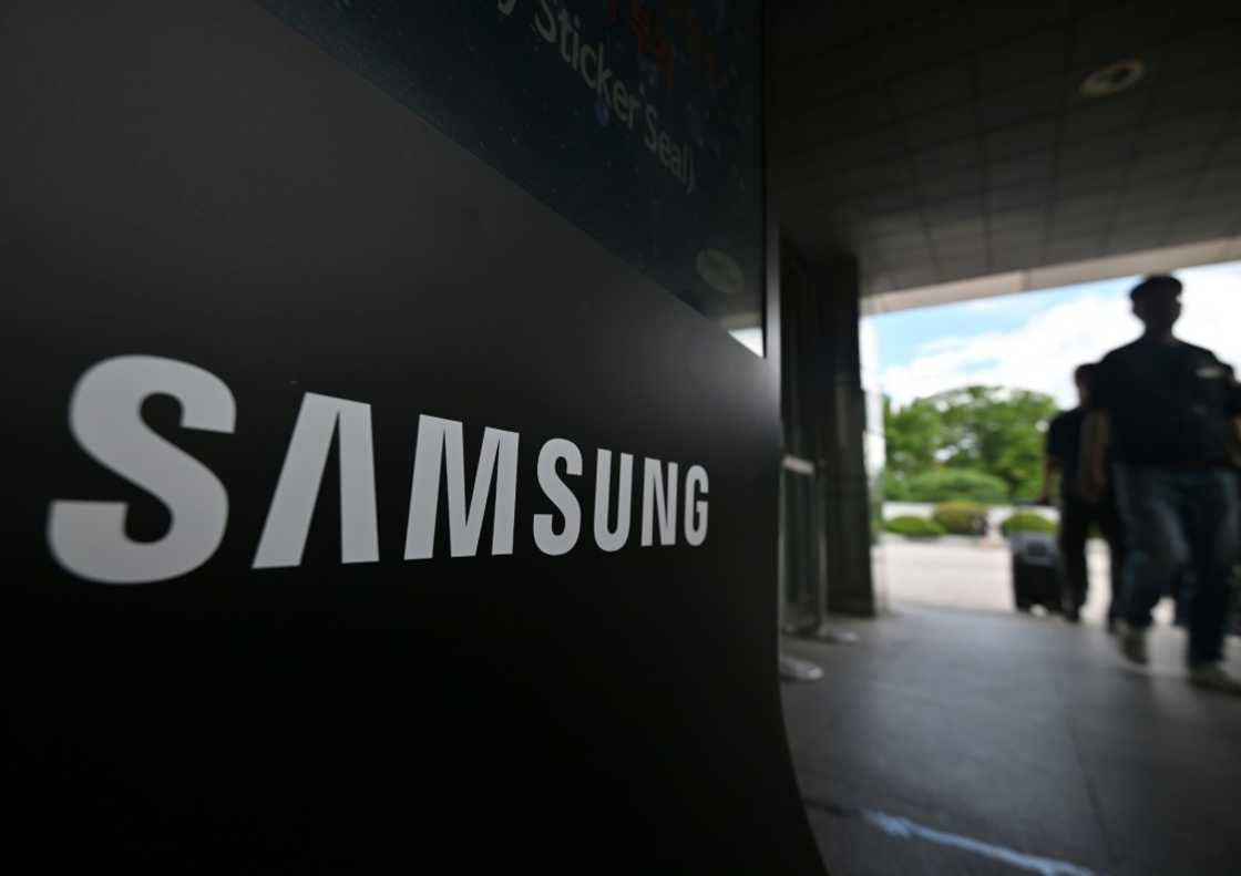 Members of the National Samsung Electronics Union walk past a Samsung logo outside the company's Giheung Campus in Yongin on July 10, 2024 Members of the National Samsung Electronics Union walk past a Samsung logo outside the company's Giheung Campus in Yongin on July 10, 2024