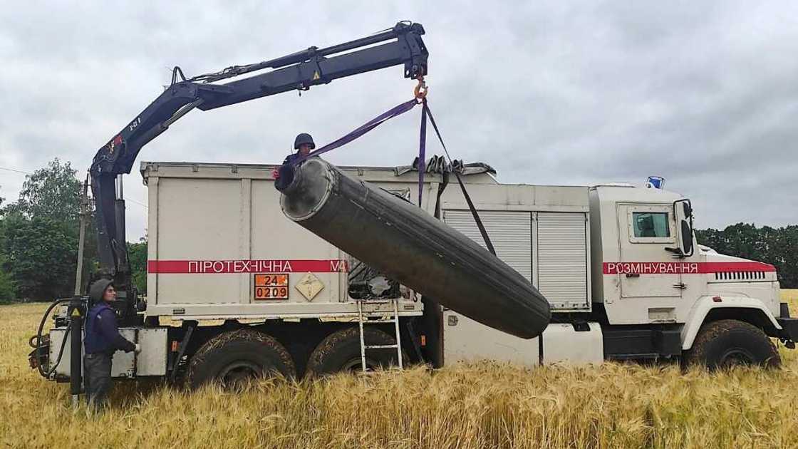 A crane lifts part of an unexploded missile from a a wheat field in UKraine's Mykolaiv region, as a deal is due to be signed tounblock grain exports A crane lifts part of an unexploded missile from a a wheat field in UKraine's Mykolaiv region, as a deal is due to be signed tounblock grain exports