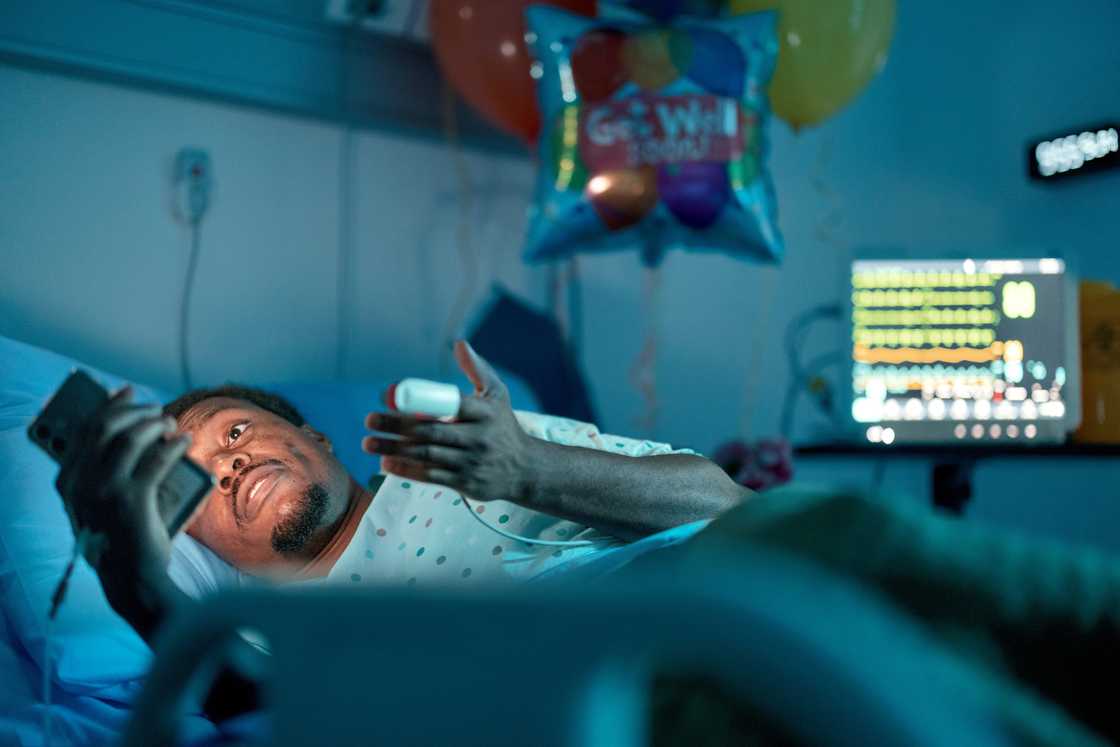 A man in hospital using his phone