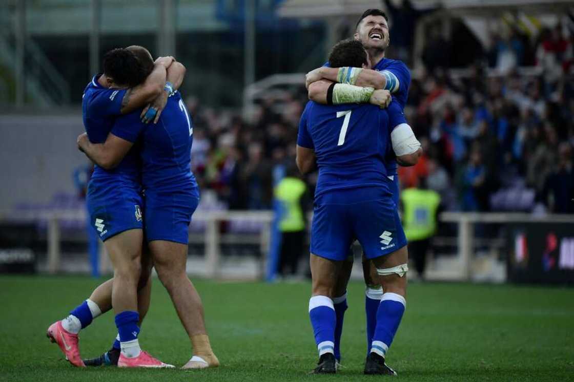 Italy's players celebrate their first victory over Australia Italy's players celebrate their first victory over Australia
