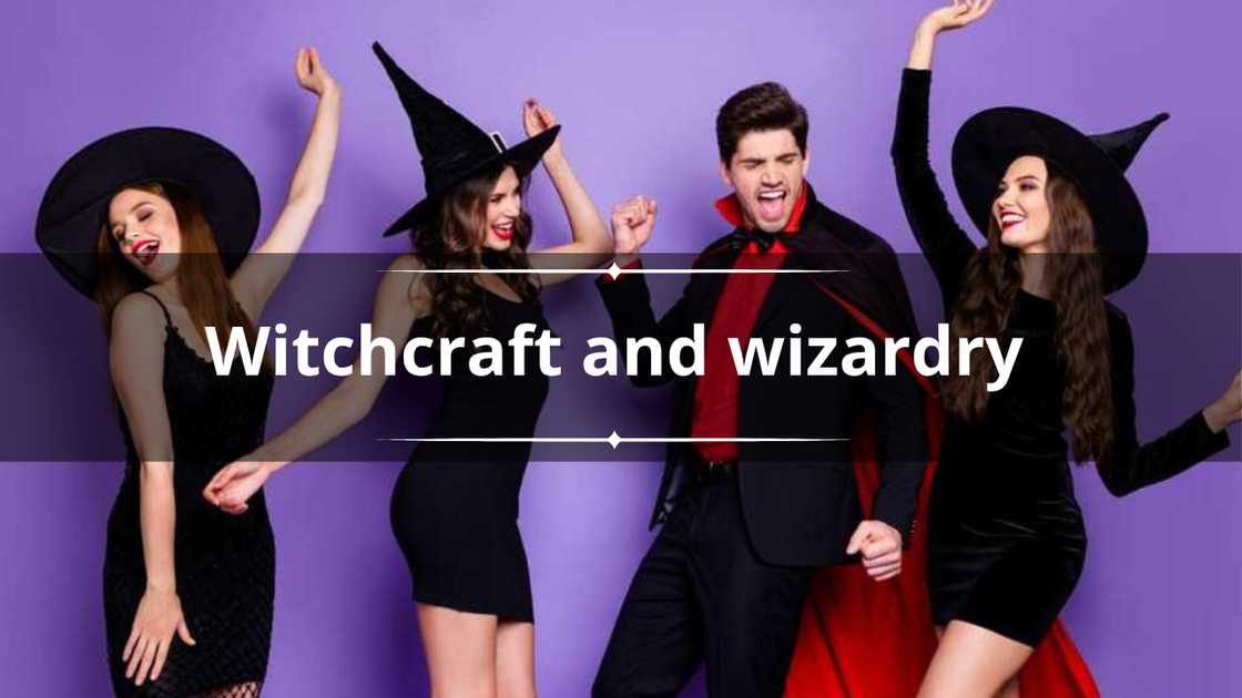 Three ladies and a warlock guy dancing at a Halloween party dancing