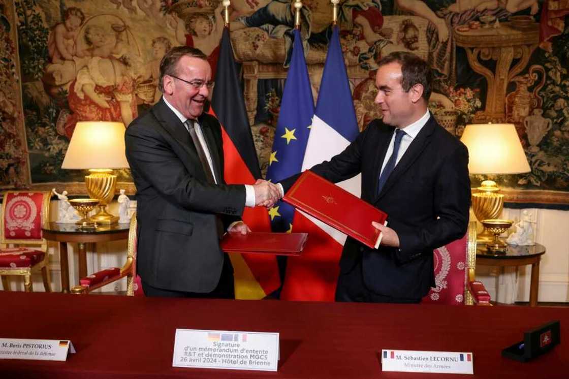 Boris Pistorius, left, and Sebastien Lecornu after signing an agreement on the MGCS 'tank of the future' project in Paris