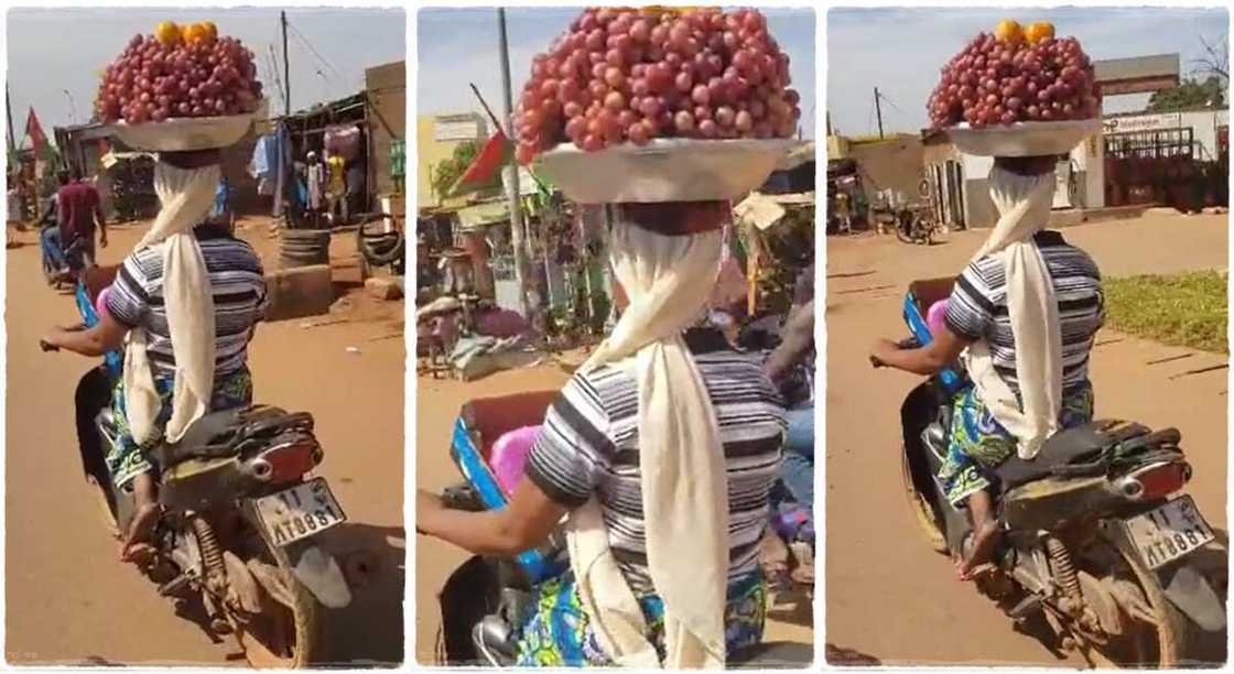 Hawker rides bike with bowl on her head. Hawker rides bike with bowl on her head.