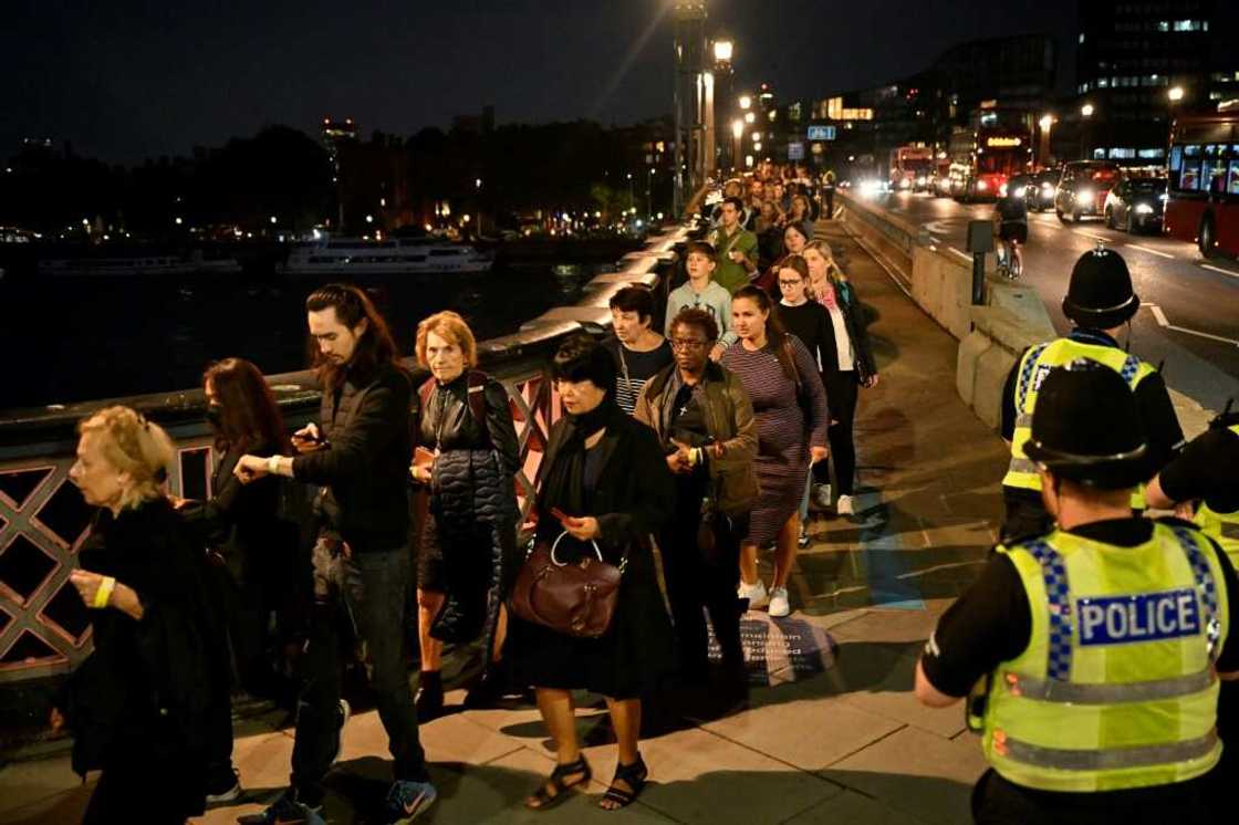 The queue snaked back for nearly three miles (five kilometres) along the Thames riverbank on Wednesday The queue snaked back for nearly three miles (five kilometres) along the Thames riverbank on Wednesday