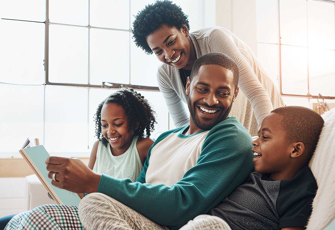 A happy black family with a book
