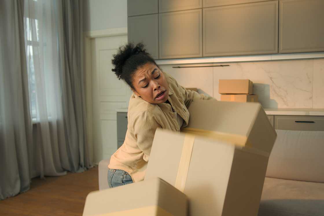 Angry black girl holds boxes