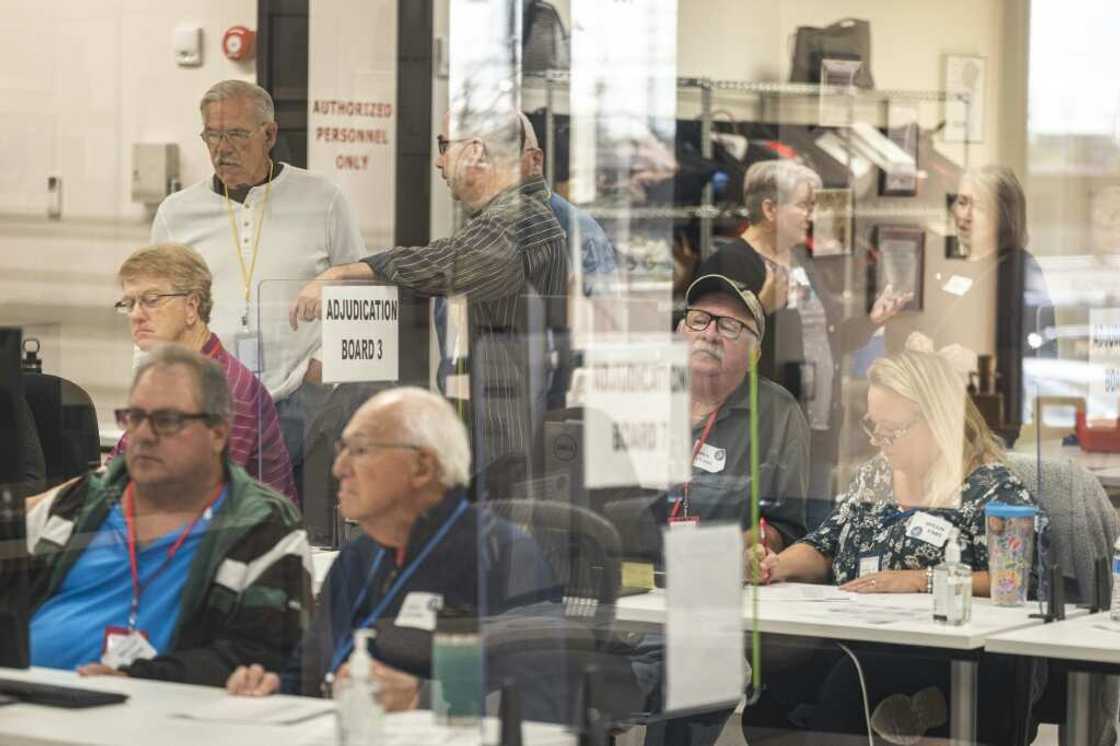 Poll workers handle ballots for the US midterm elections, in the presence of observers from both Democratic and Republican parties, at the Maricopa County Tabulation and Elections Center (MCTEC) in Phoenix, Arizona on October 25, 2022 Poll workers handle ballots for the US midterm elections, in the presence of observers from both Democratic and Republican parties, at the Maricopa County Tabulation and Elections Center (MCTEC) in Phoenix, Arizona on October 25, 2022