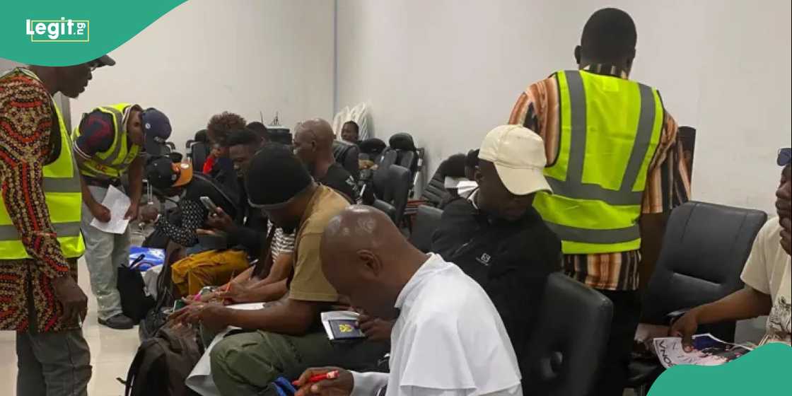 Nigerian returnees are received by officials after landing from Johannesburg.
