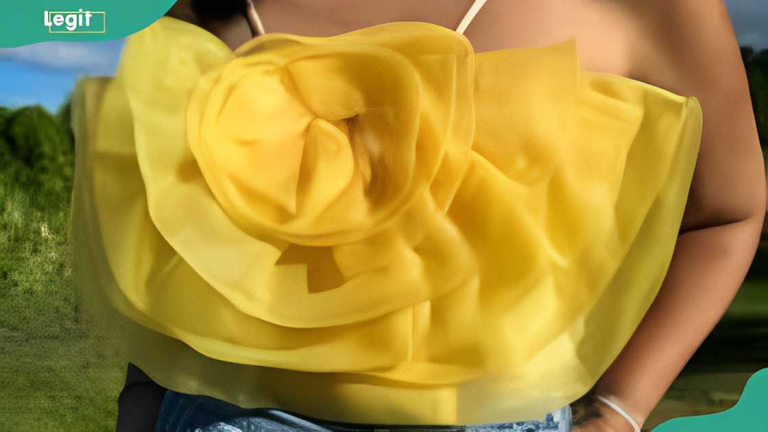 A lady donning a yellow flower organza top A lady donning a yellow flower organza top