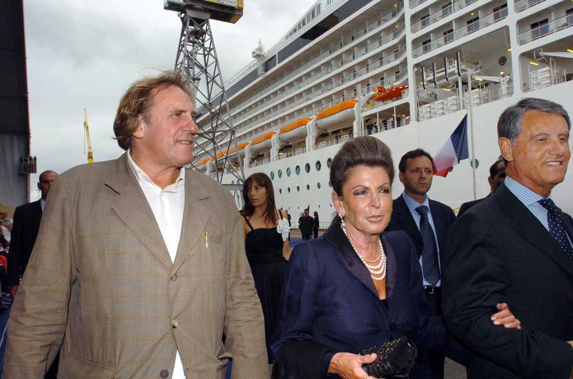 Gerard Depardieu (L) arrives next to Gianluigi Aponte (R), and his wife Rafaela Aponte (C) before the inauguration of the cruise ship Msc Musica