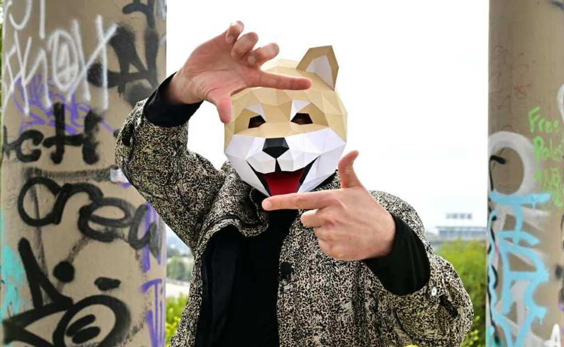Tridog, a member of Own the Doge, wears a Doge mask as he poses for photos during an interview in Los Angeles Tridog, a member of Own the Doge, wears a Doge mask as he poses for photos during an interview in Los Angeles
