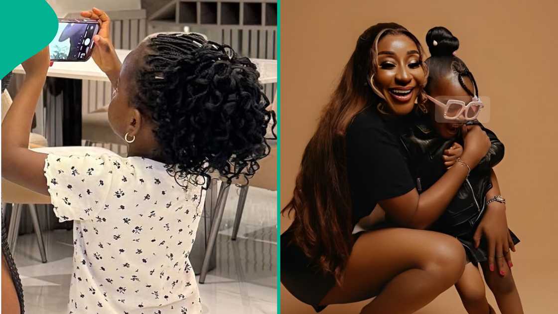 Ini Edo's child takes pictures of her. Ini Edo's child takes pictures of her.