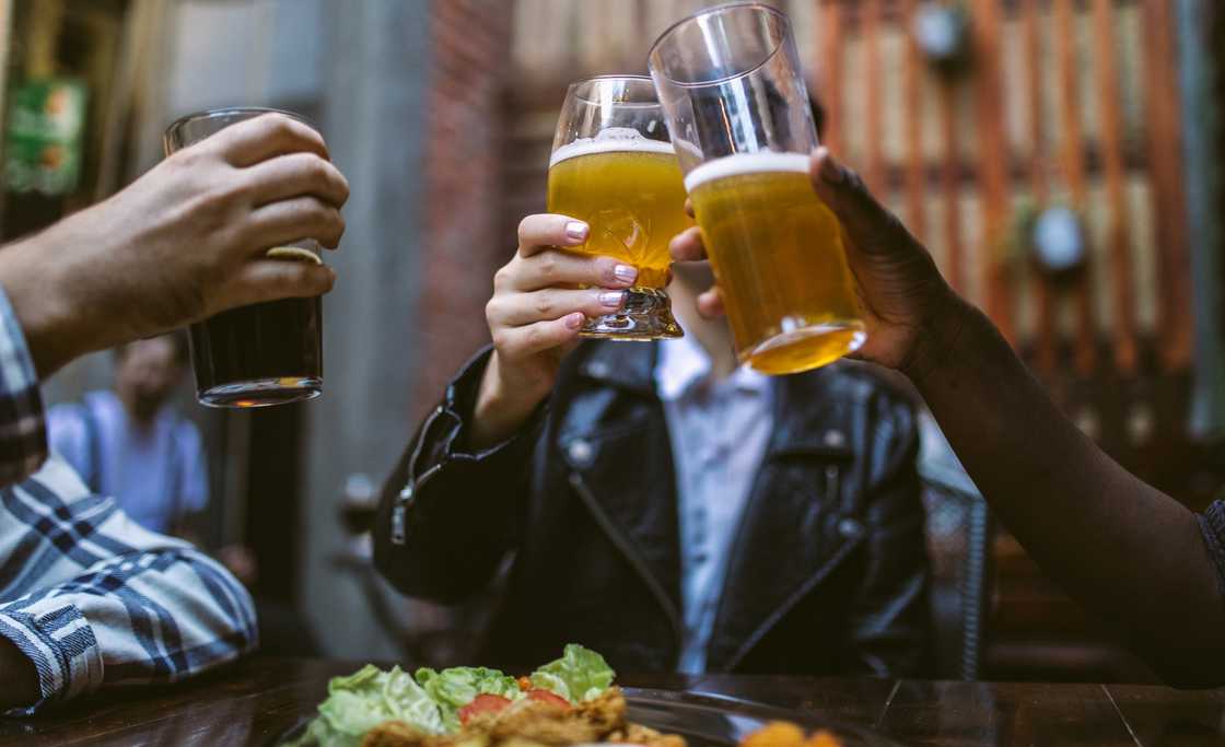 A group of people toasting on lunch at a restaurant A group of people toasting on lunch at a restaurant