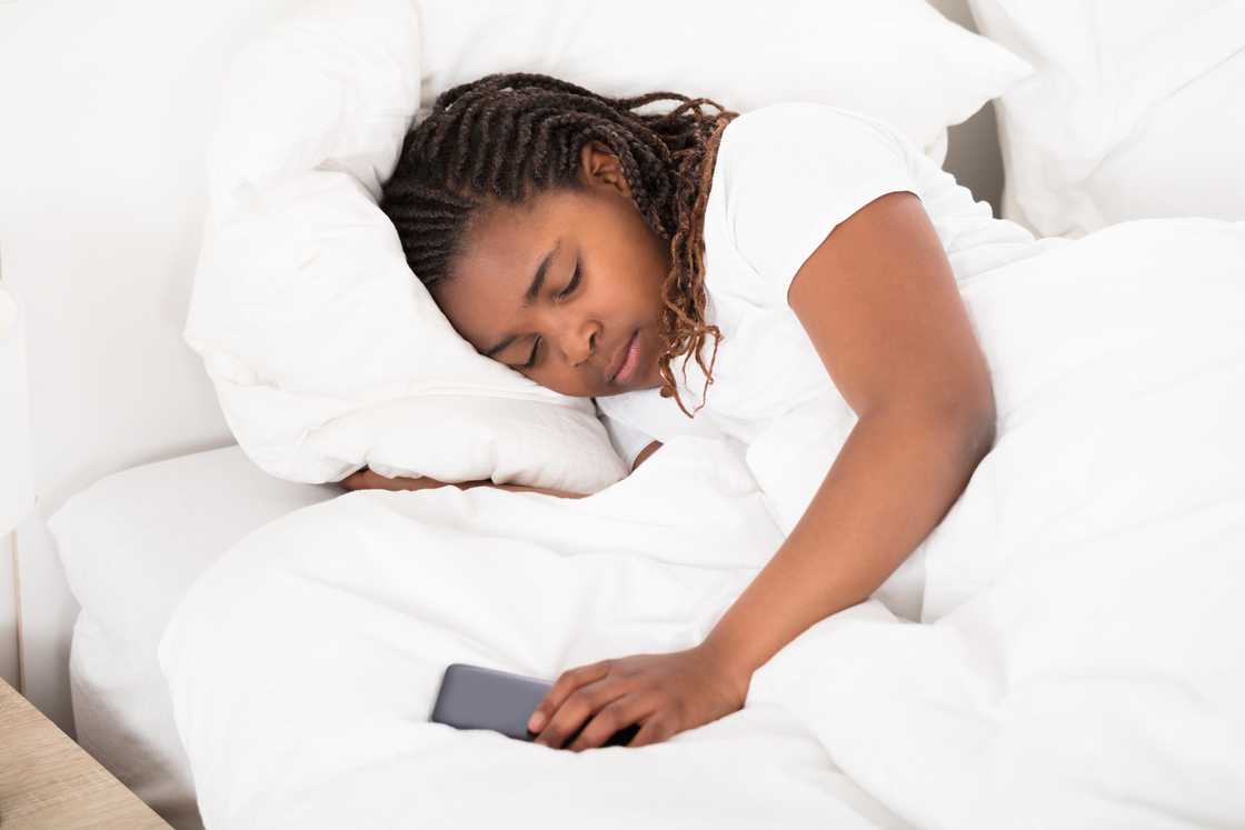 A girl sleeping with her phone