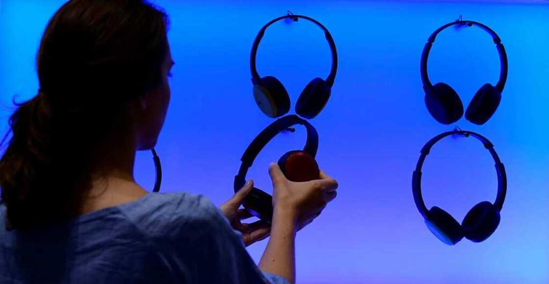 A woman poses at an installation showing headphones at the booth of JVC at the IFA (Internationale Funkausstellung) electronics trade fair in Berlin on September 1, 2016 A woman poses at an installation showing headphones at the booth of JVC at the IFA (Internationale Funkausstellung) electronics trade fair in Berlin on September 1, 2016