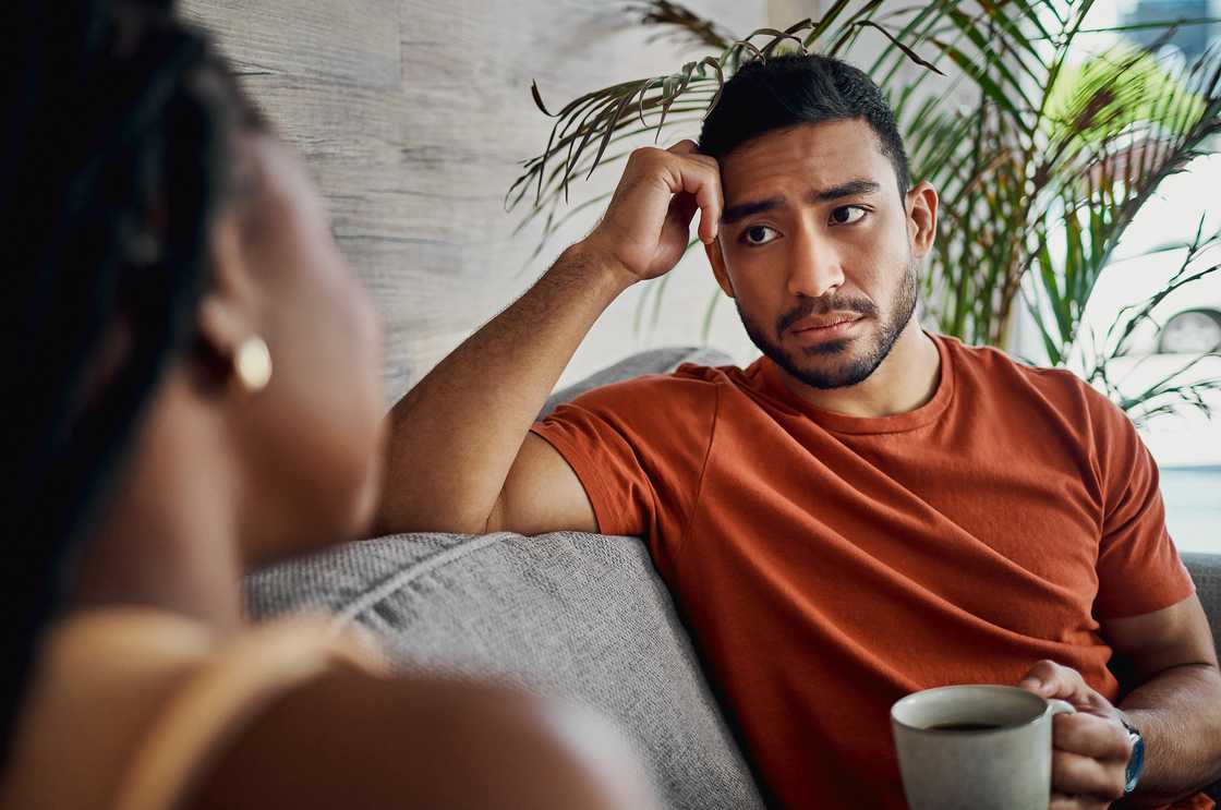 A young man and woman sitting in the living room