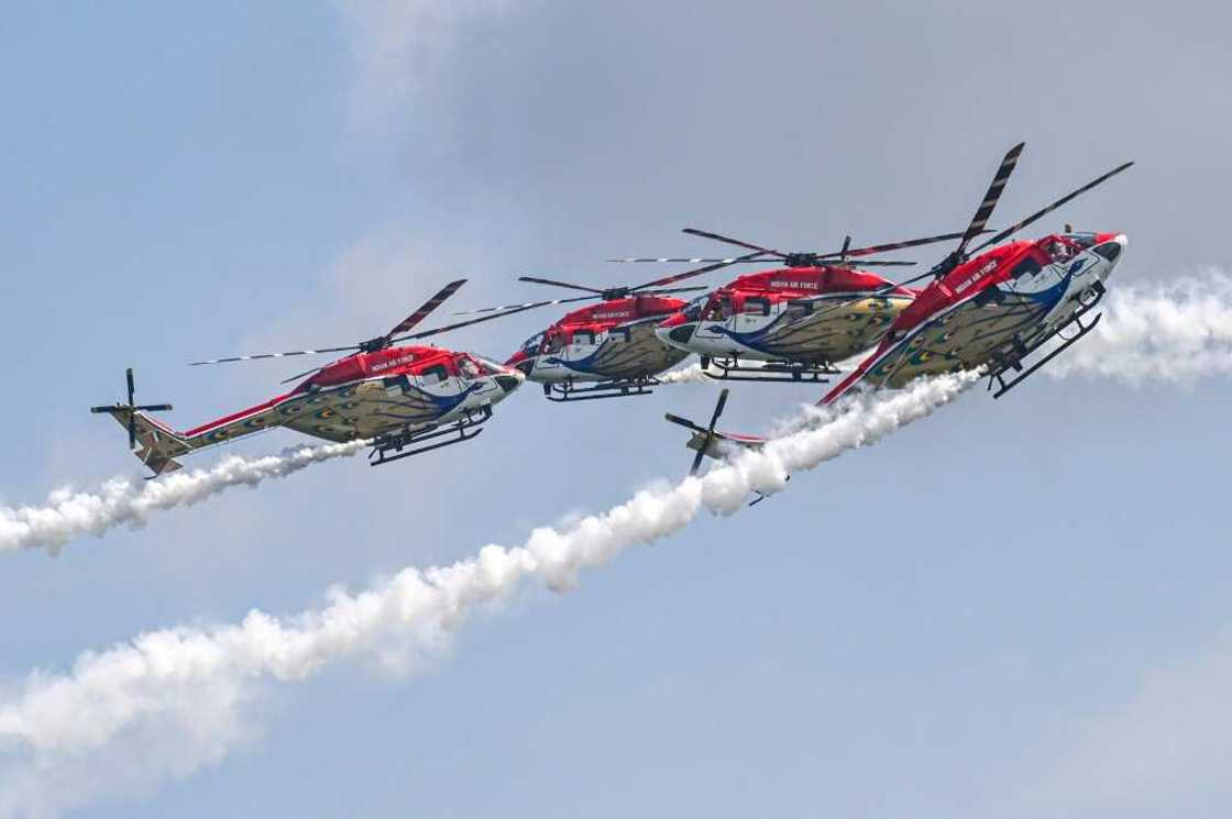 Members of the Sarang Helicopter Display Team of the Indian Air Force (IAF) perform with modified HAL Dhruv helicopters, also known as Advanced Light Helicopter (ALH), during a preview of the Singapore Airshow in Singapore on February 18, 2024 Members of the Sarang Helicopter Display Team of the Indian Air Force (IAF) perform with modified HAL Dhruv helicopters, also known as Advanced Light Helicopter (ALH), during a preview of the Singapore Airshow in Singapore on February 18, 2024
