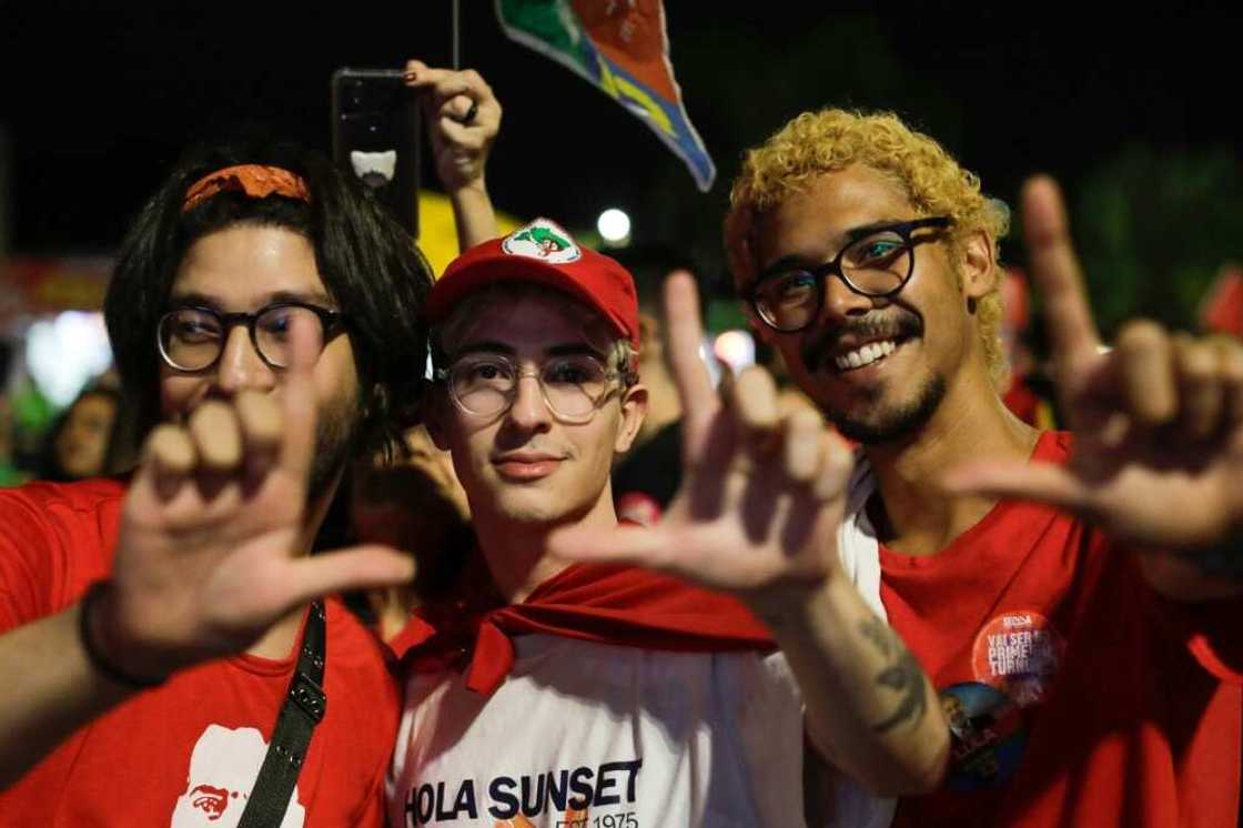 Supporters of former Brazilian president Luiz Inacio Lula da Silva make an 'L' sign with their hands, signalling support for Lula Supporters of former Brazilian president Luiz Inacio Lula da Silva make an 'L' sign with their hands, signalling support for Lula