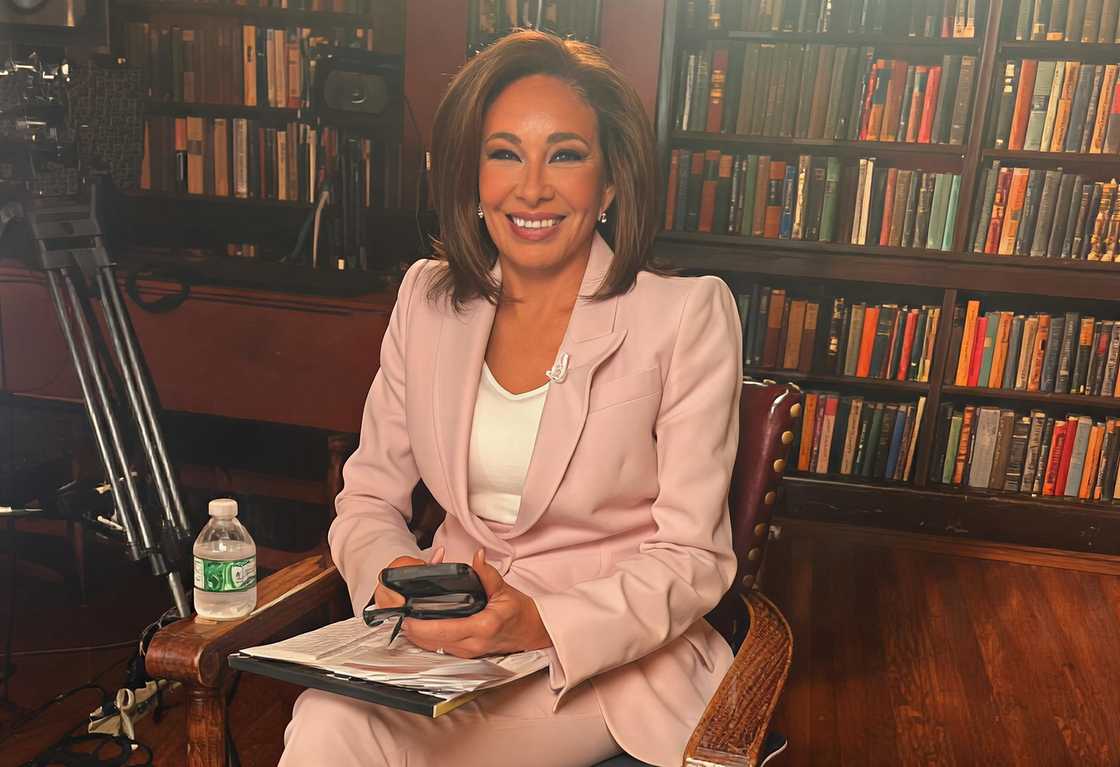 Judge Jeanine Pirro sits in front of a bookshelf during her Sanctuary America interview.