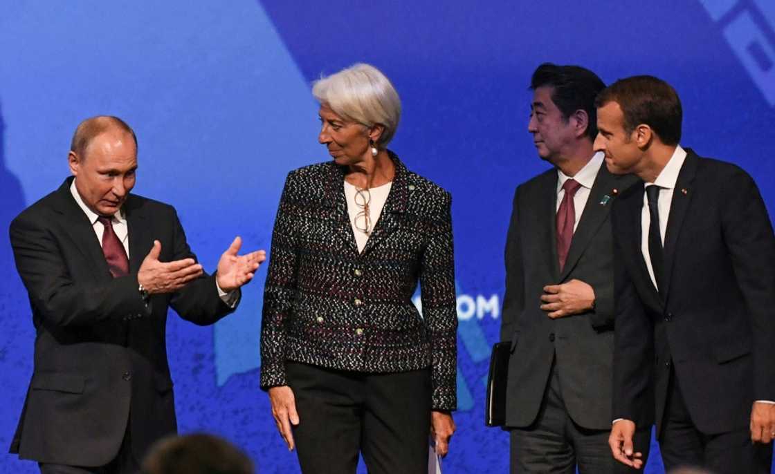 France's Emmanuel Macron and Japan's Shinzo Abe sat on stage alongside Putin at SPIEF in 2018 France's Emmanuel Macron and Japan's Shinzo Abe sat on stage alongside Putin at SPIEF in 2018