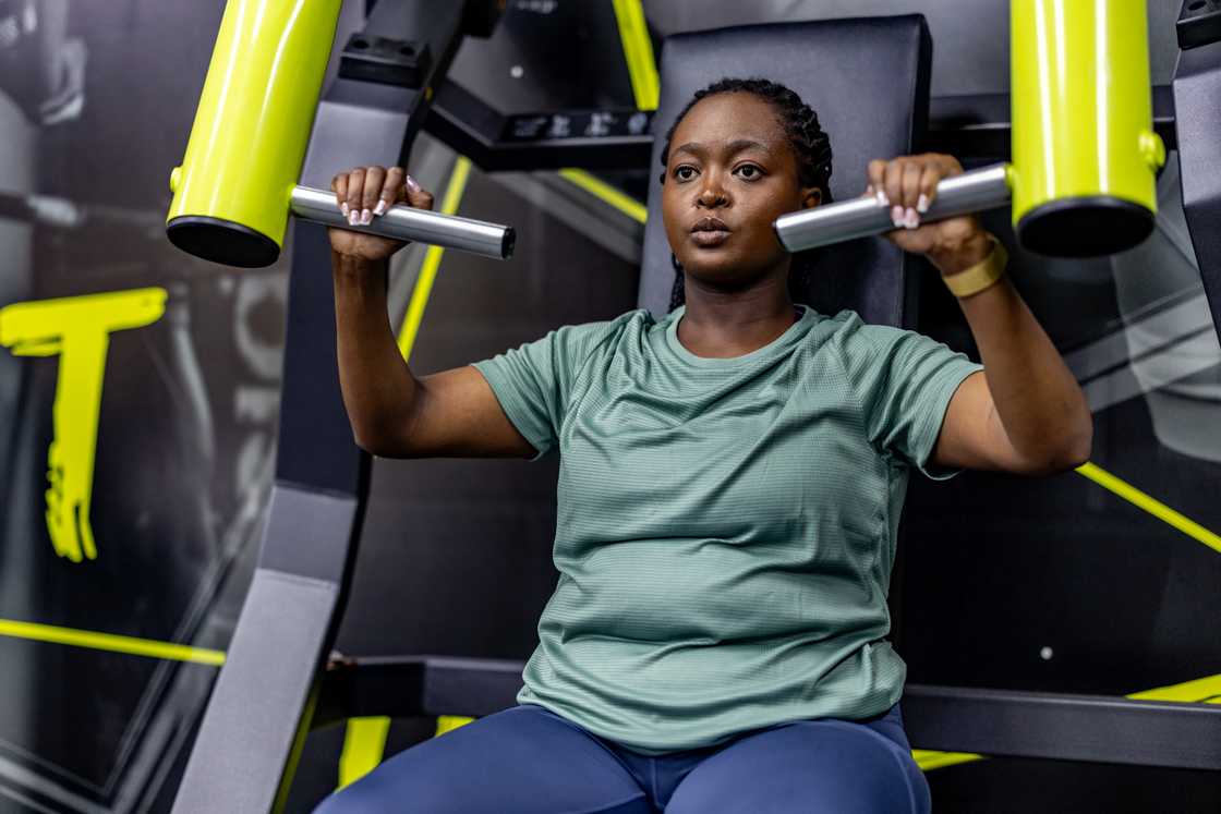 A focused woman is working out at the gym