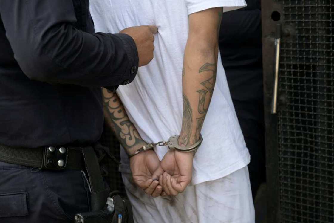A man captured for alleged gang links is escorted by the National Civil Police during the state of emergency declared by the government in San Salvador on March 31, 2022 A man captured for alleged gang links is escorted by the National Civil Police during the state of emergency declared by the government in San Salvador on March 31, 2022