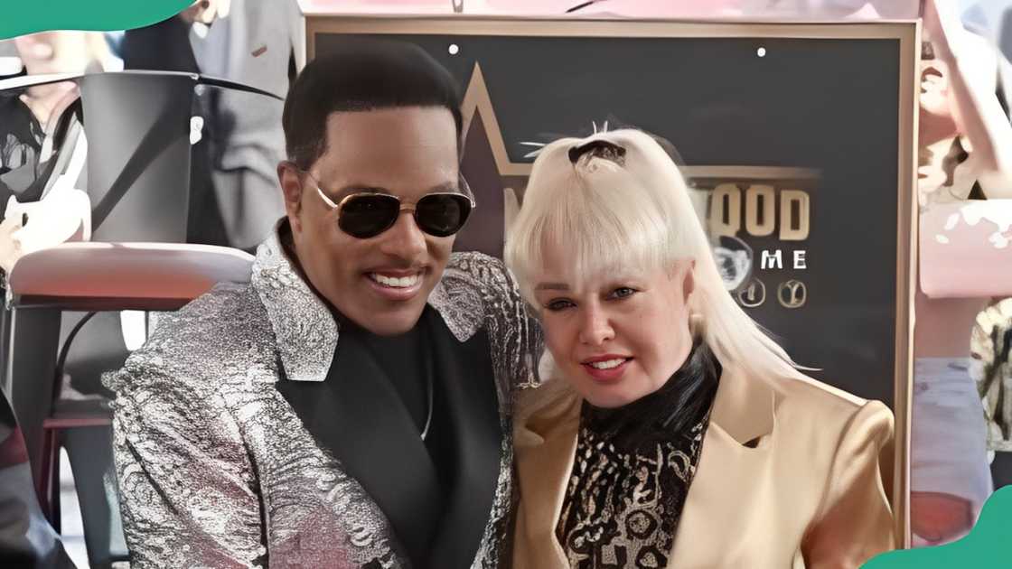 Charlie Wilson and Mahin Tat pose for a photo at an event