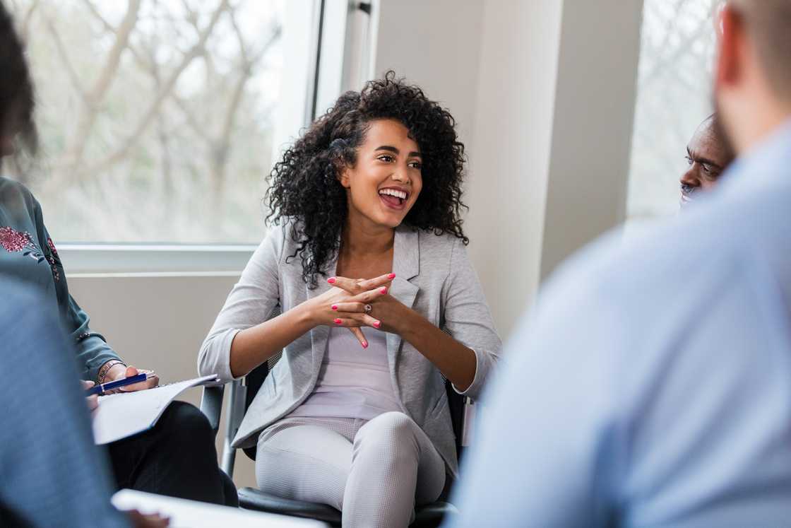 Smiling woman laughing joyfully in a therapy session