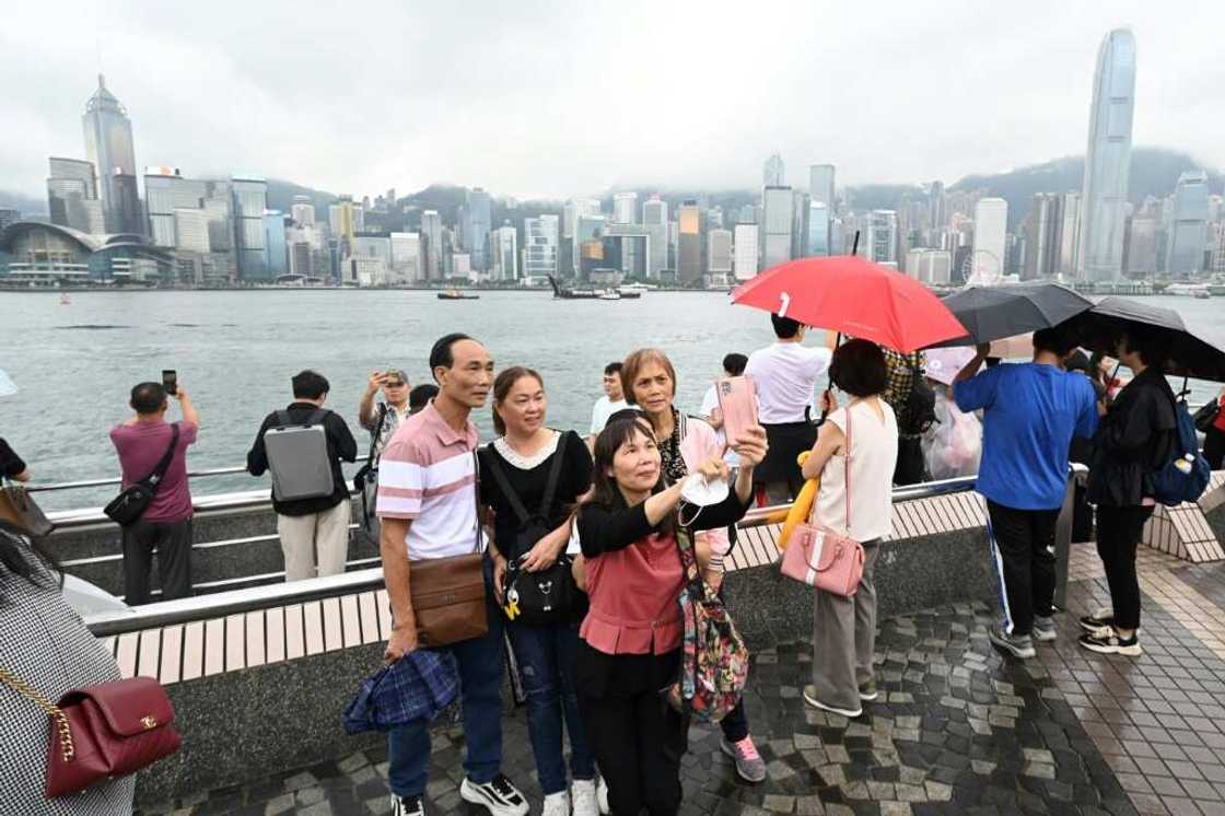 Tourists from mainland China visit the Tsim Sha Tsui waterfront in Hong Kong on May 1, the start of the 'Golden Week' holiday